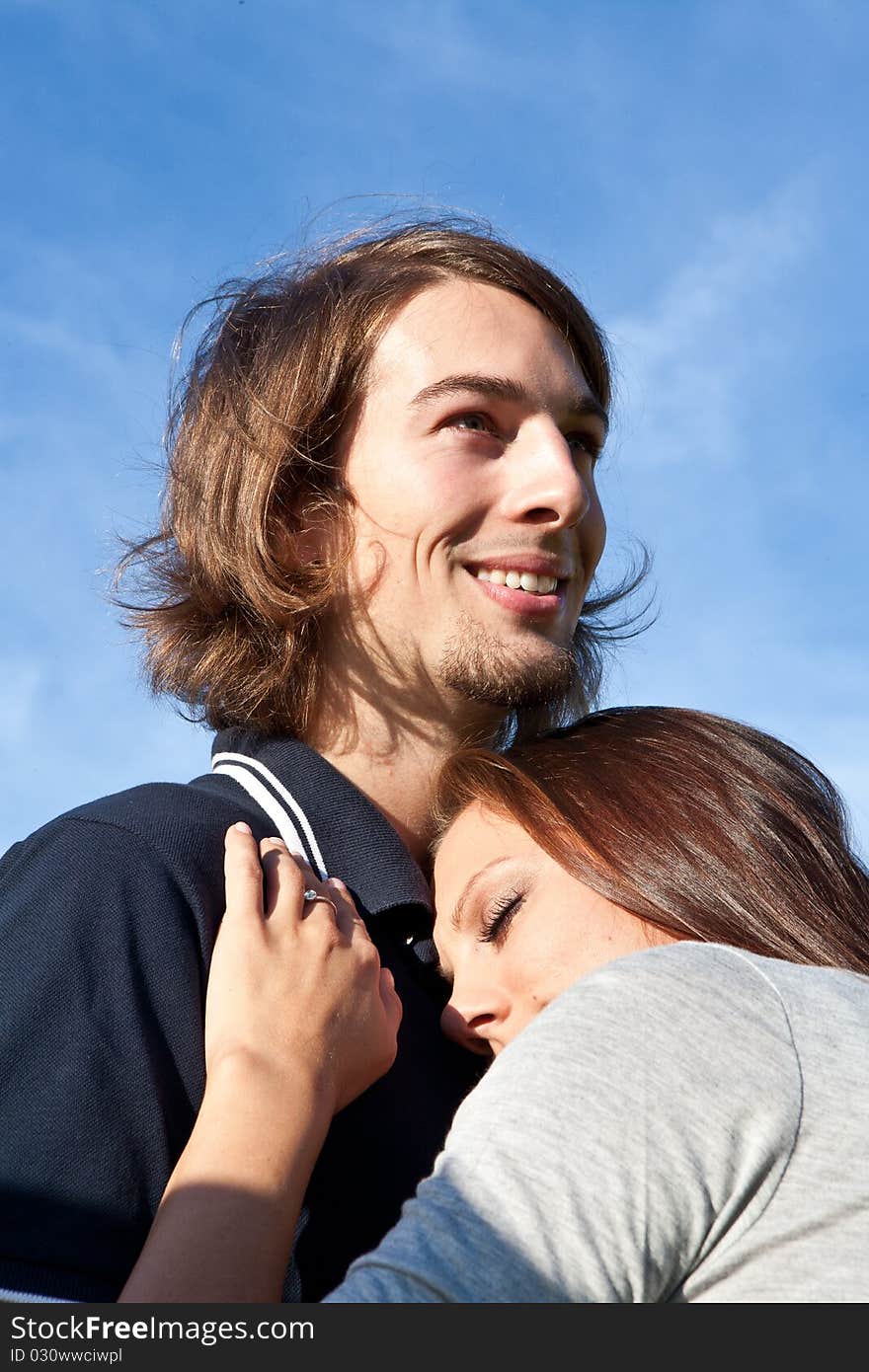 Young couple in love with blue sky in the background. Young couple in love with blue sky in the background