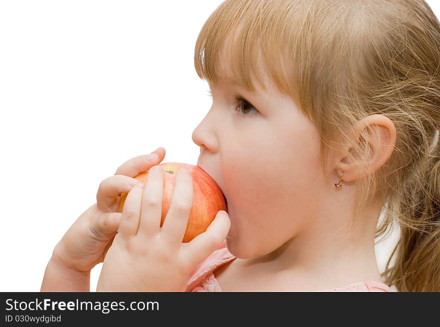 The little girl eats an apple isolated over white