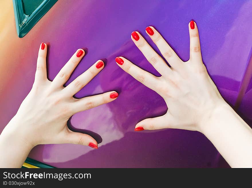 Two hands with with thumbs up on surface of car. Two hands with with thumbs up on surface of car