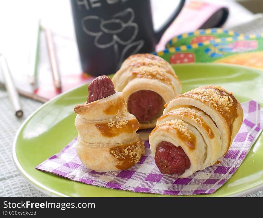 Sausage in dough for breafast for children. Selective focus. Sausage in dough for breafast for children. Selective focus