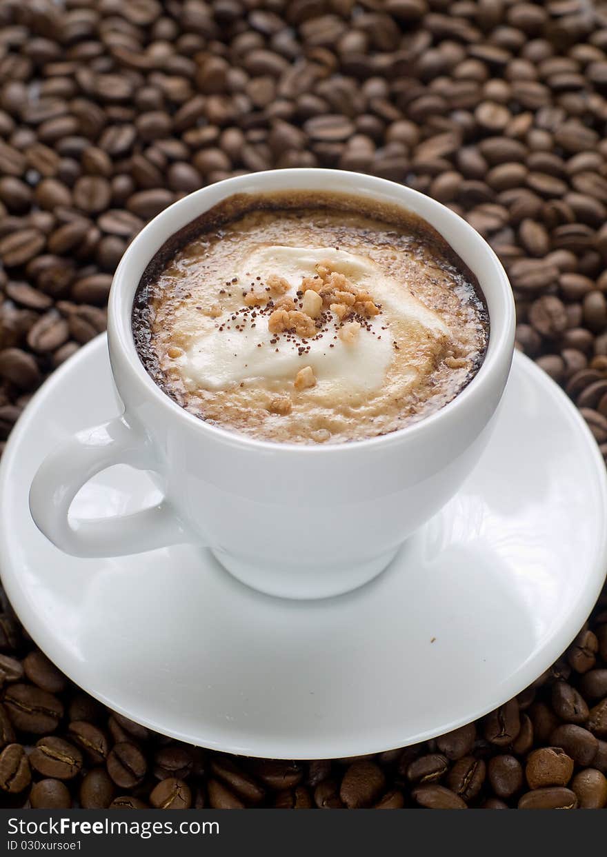 Cup of Cappuccino coffee on a wood table with cookies