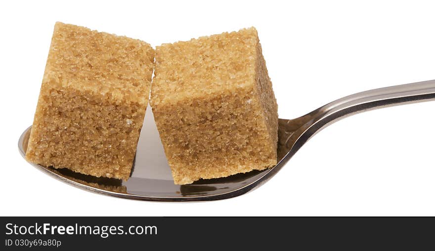 Cube of brown sugar on spoon, isolated on white with clipping path