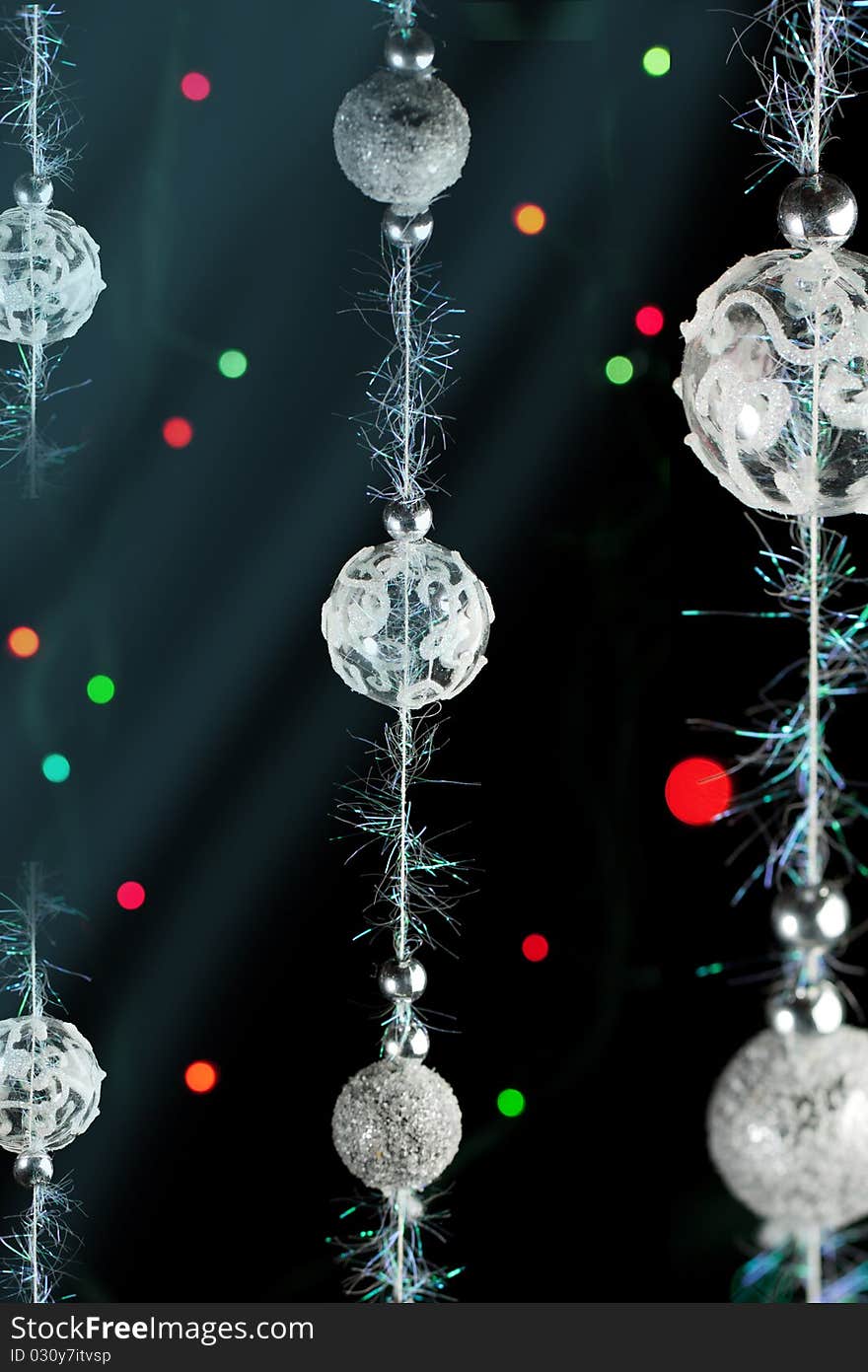 Silver christmas balls with a colorful lights on the black background. Silver christmas balls with a colorful lights on the black background