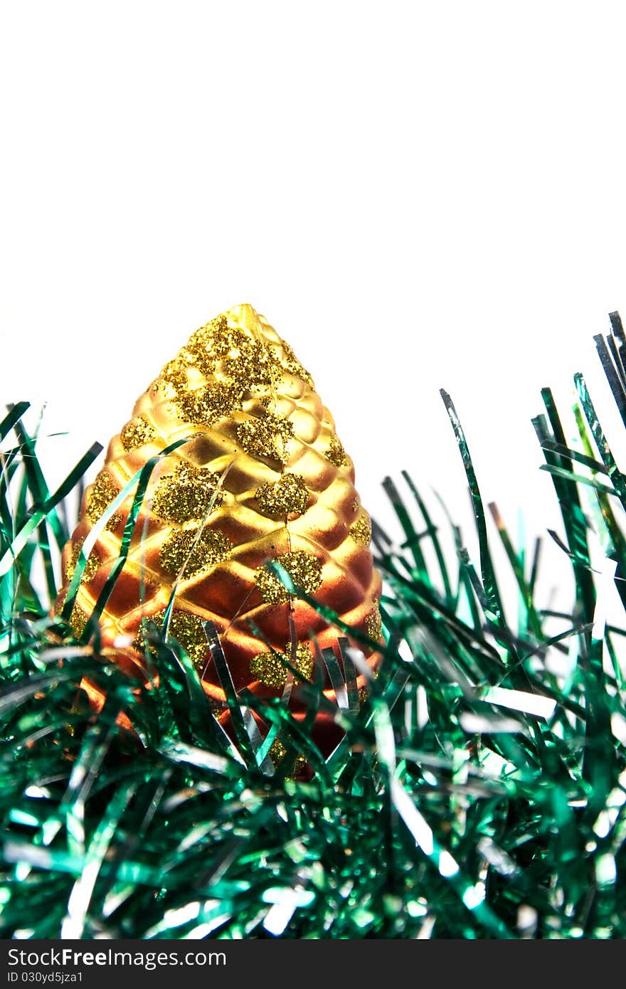 Detail of a pine christmas decoration on green tinsel