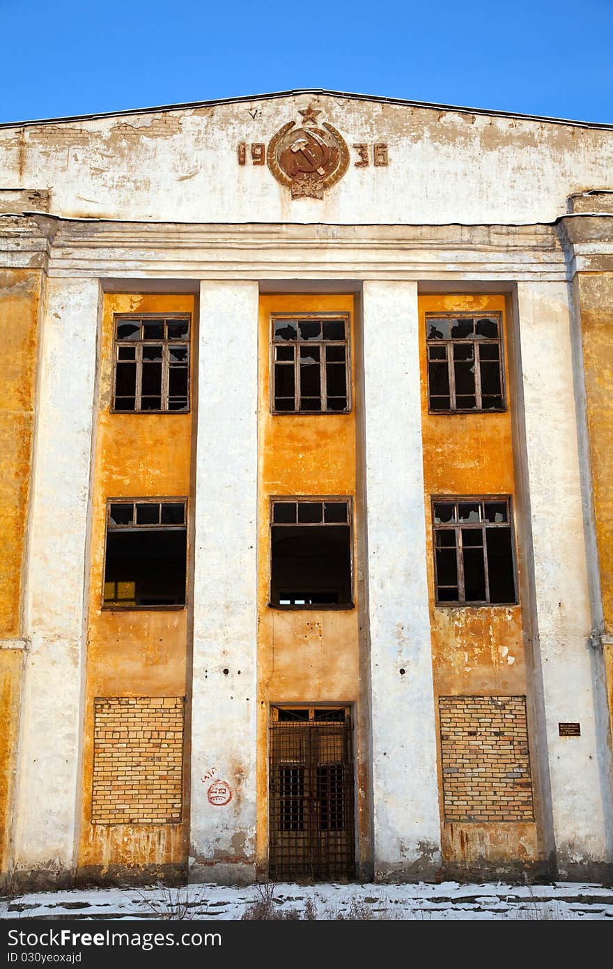 Abandoned army barracks against the blue sky