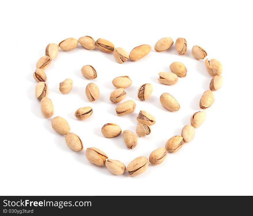 Heart of the pistachios on a white background