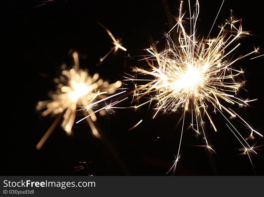 Burning sparkler on New Year�s Eve. Burning sparkler on New Year�s Eve