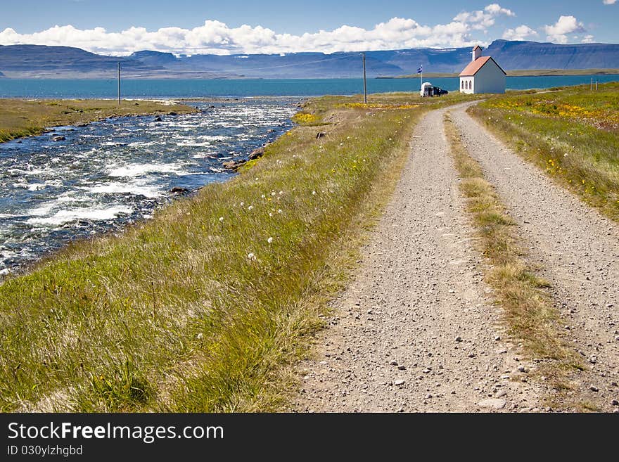 River, gravel route, old white church - Unadsdalur, Iceland. Summerday. River, gravel route, old white church - Unadsdalur, Iceland. Summerday