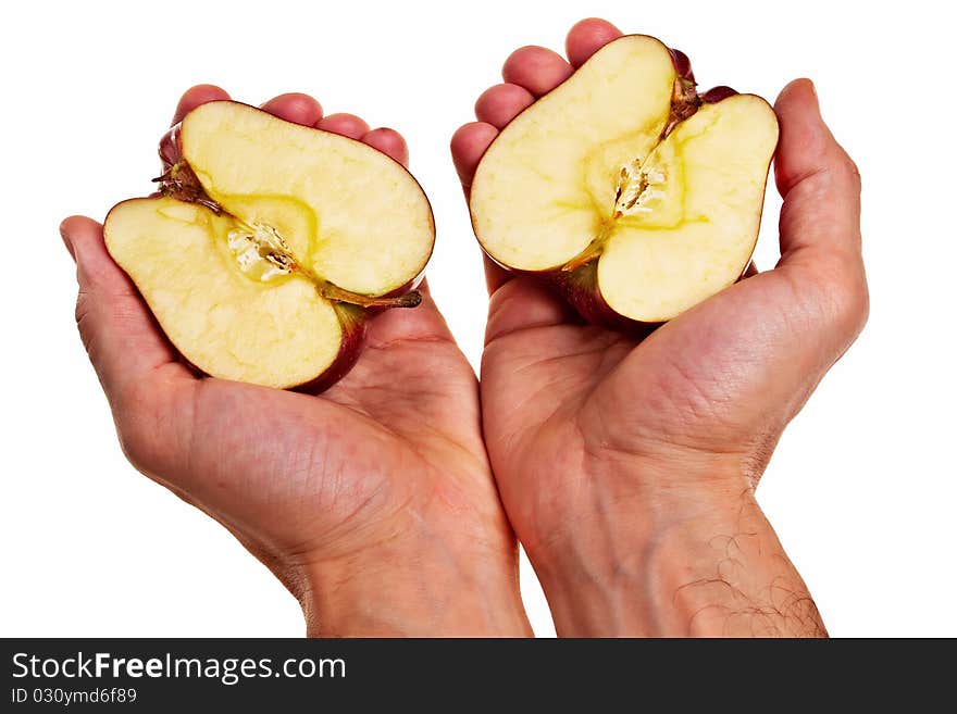 Red apple cut into two parts in male white hands isolated over white background. Red apple cut into two parts in male white hands isolated over white background.