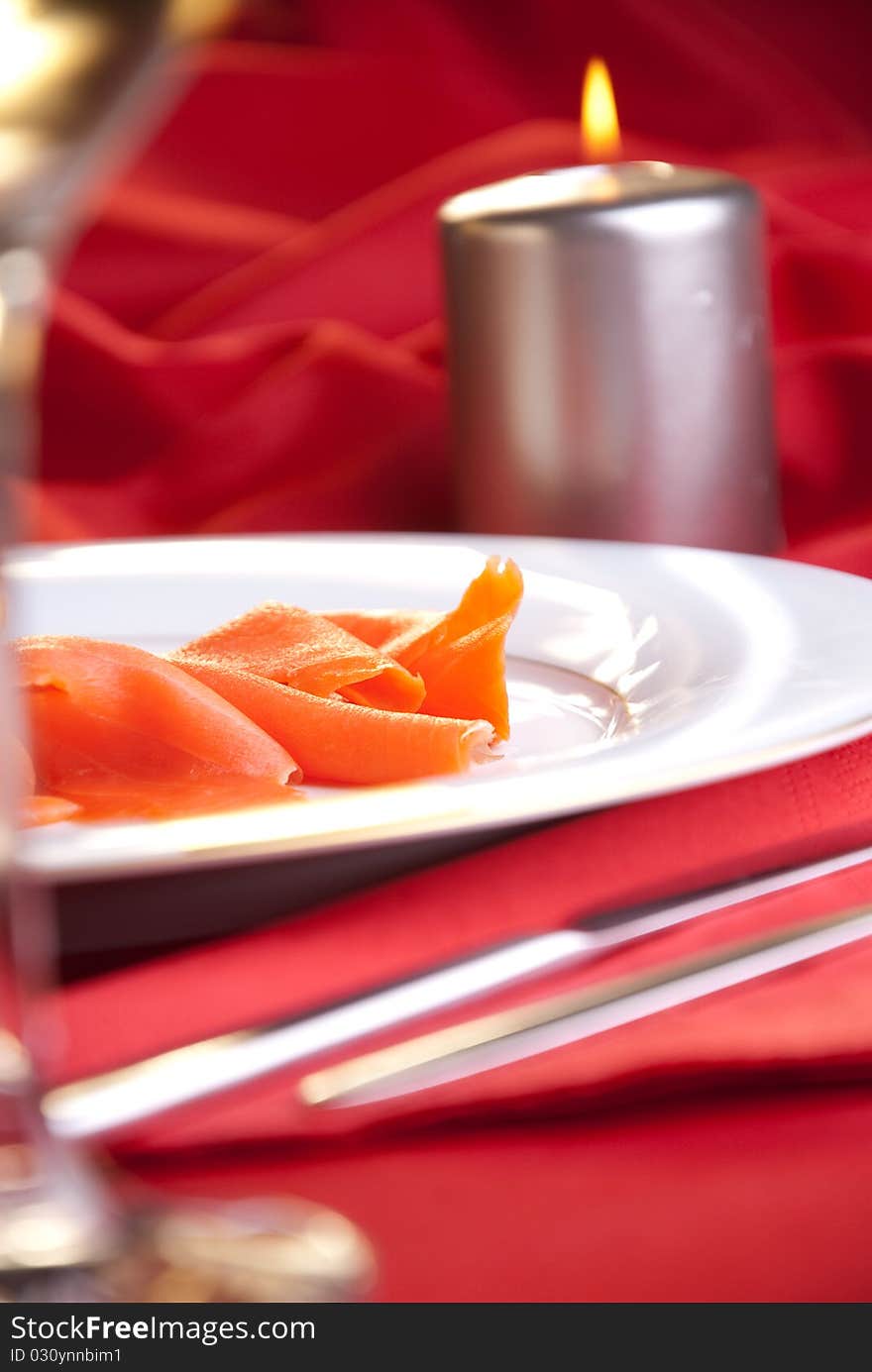 Smoked salmon with chives for Christmas, on a red-decorated table. Smoked salmon with chives for Christmas, on a red-decorated table