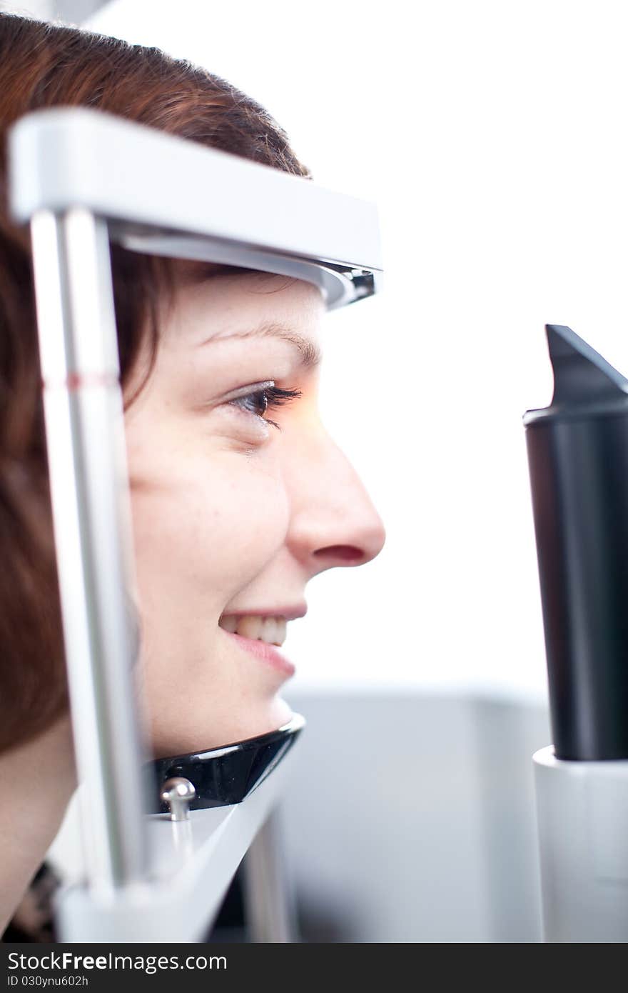 Young woman having her eyes examined