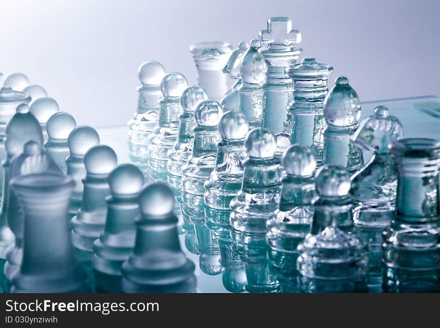 Transparent glass chess pieces in blue