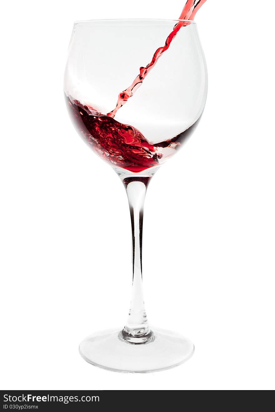 Red wine pouring into wine glass