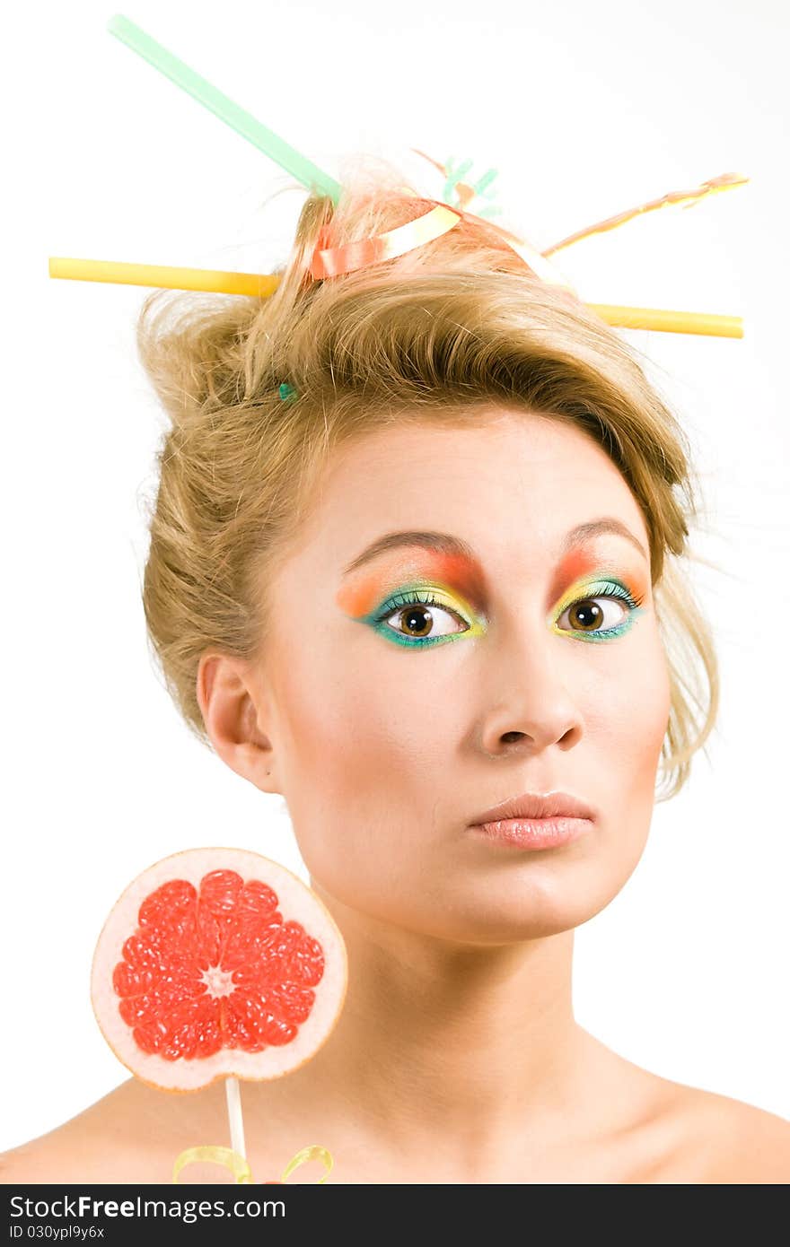 Beauty girl with a piece of grapefruit on a stick. Beauty girl with a piece of grapefruit on a stick