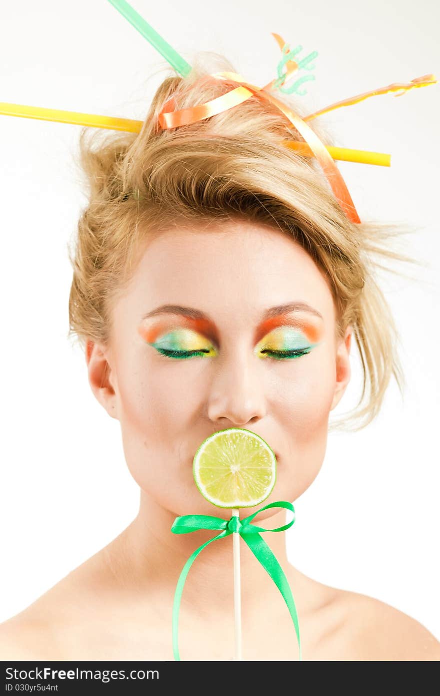 Beauty girl close one's mouth piece of lime on a stick. Beauty girl close one's mouth piece of lime on a stick