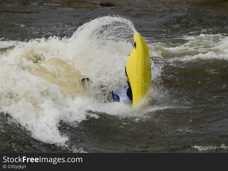 A freestyle kayaker navigates through river rapids in Steamboat Springs, Colorado