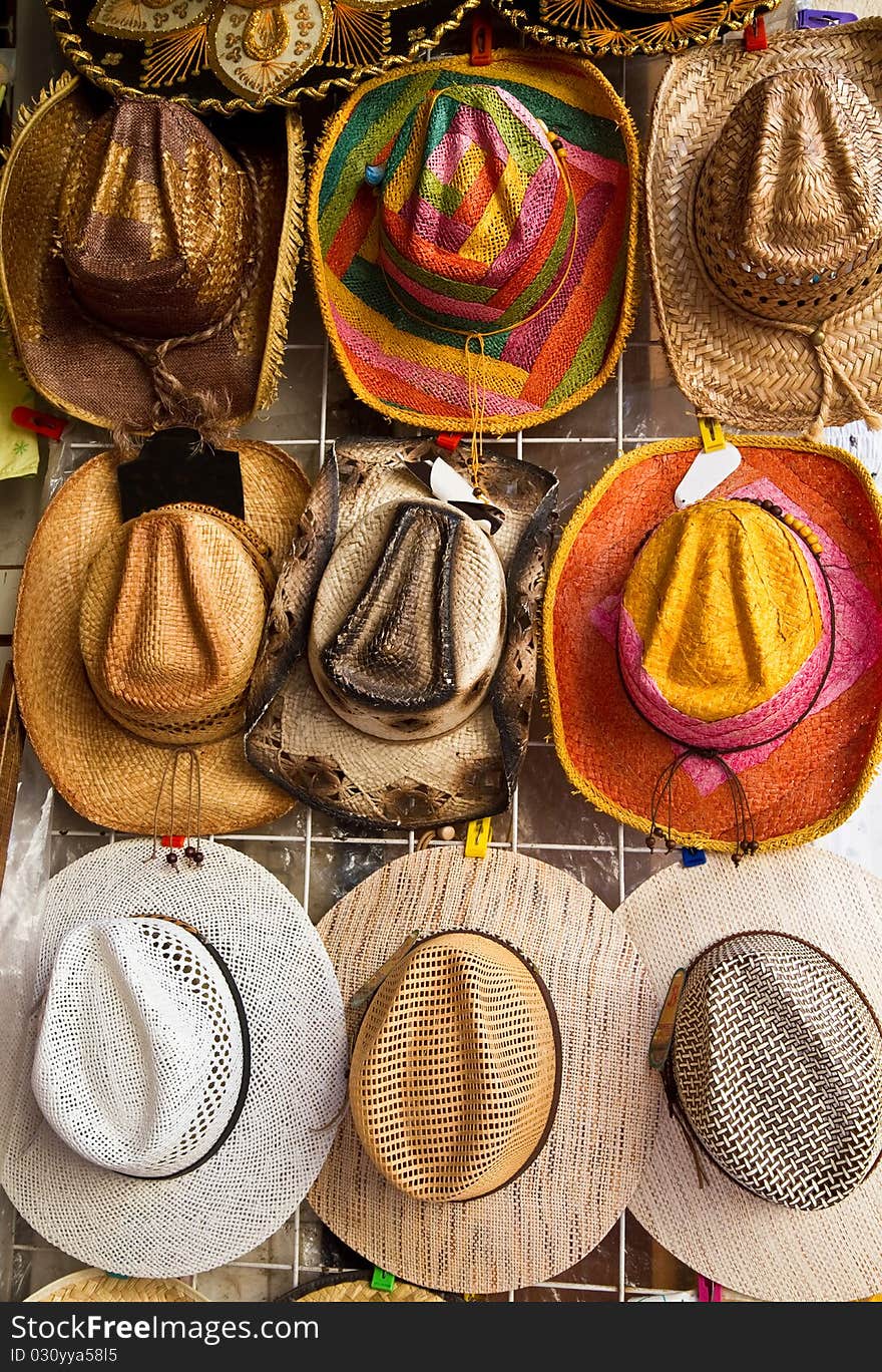 Souvenir hats hanging on the wall in a flea market