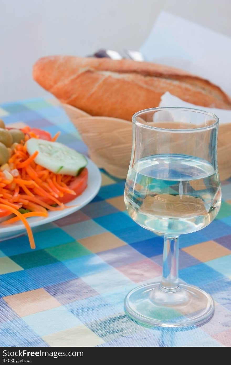 Still life with a salad and a glass of wine