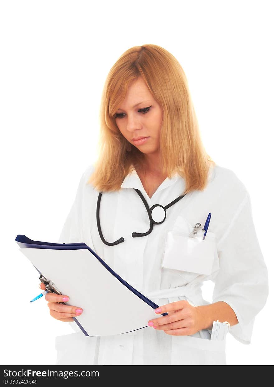 Young blonde girl in hospital gown with a stethoscope carefully examining the patient's diagnosis. Nurse isolated on white background. Young blonde girl in hospital gown with a stethoscope carefully examining the patient's diagnosis. Nurse isolated on white background.