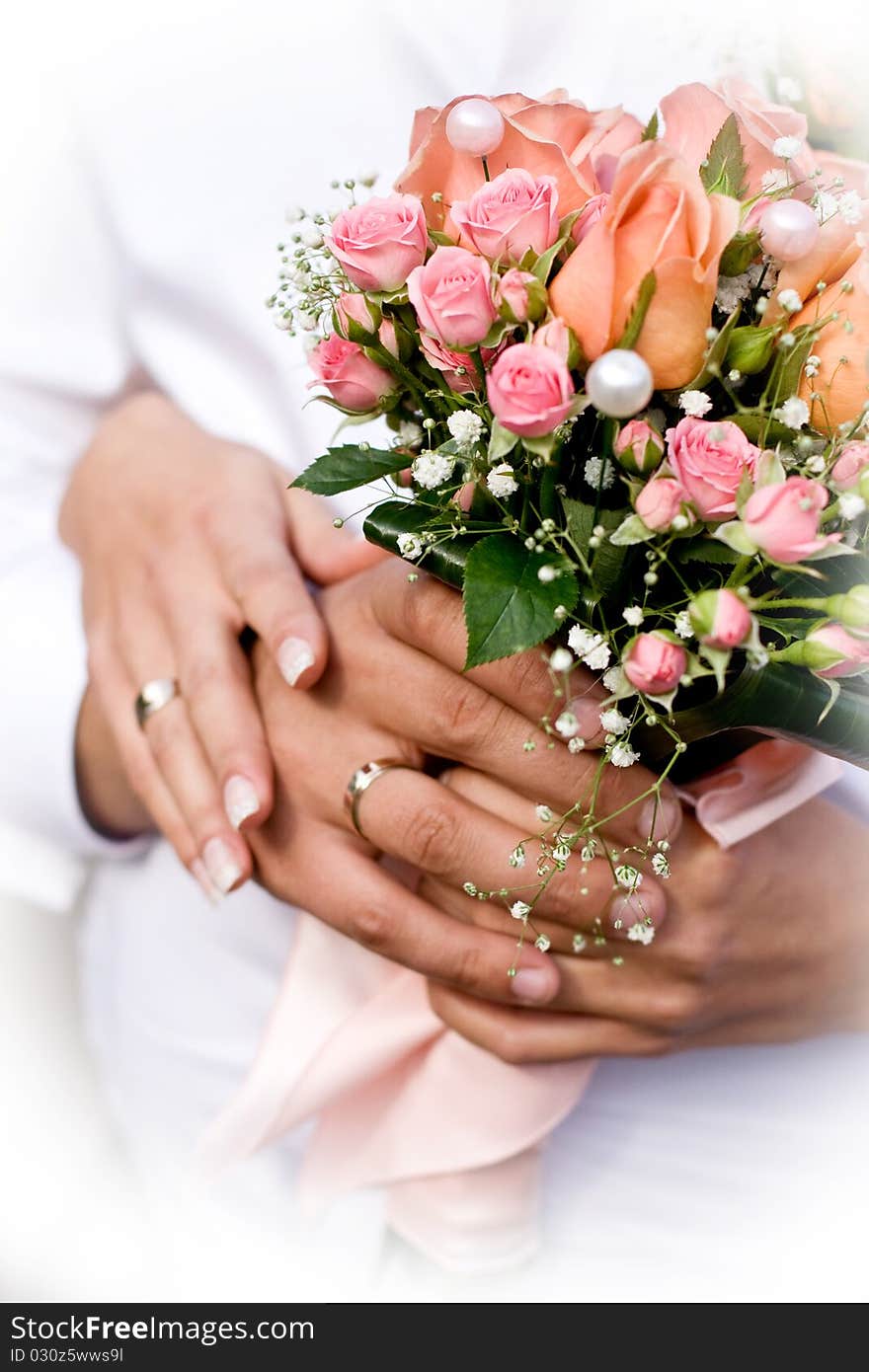 Wife and husband holding wedding bouquet. Wife and husband holding wedding bouquet