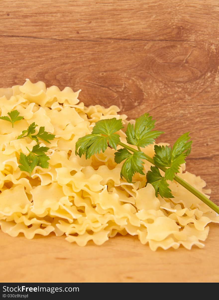 Pasta with green spice to a wooden board