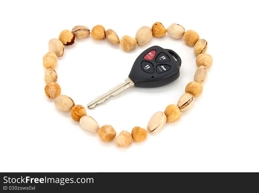 Nuts shaped into a heart as a symbol of how much of eating nuts would benefit the heart and the body. and A car's key as a gift. So you can now win the heart of your partner by good nutrition and a good gift. Nuts shaped into a heart as a symbol of how much of eating nuts would benefit the heart and the body. and A car's key as a gift. So you can now win the heart of your partner by good nutrition and a good gift.