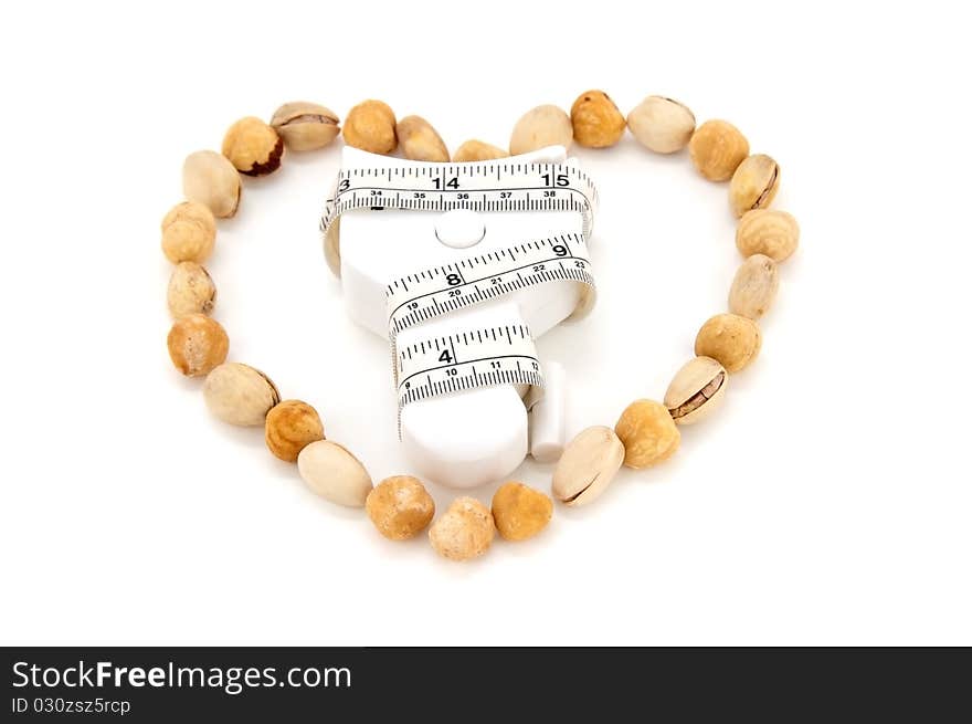 Nuts shaped into a heart as a symbol of how much of eating nuts would benefit the heart and the body. Nuts shaped into a heart as a symbol of how much of eating nuts would benefit the heart and the body.