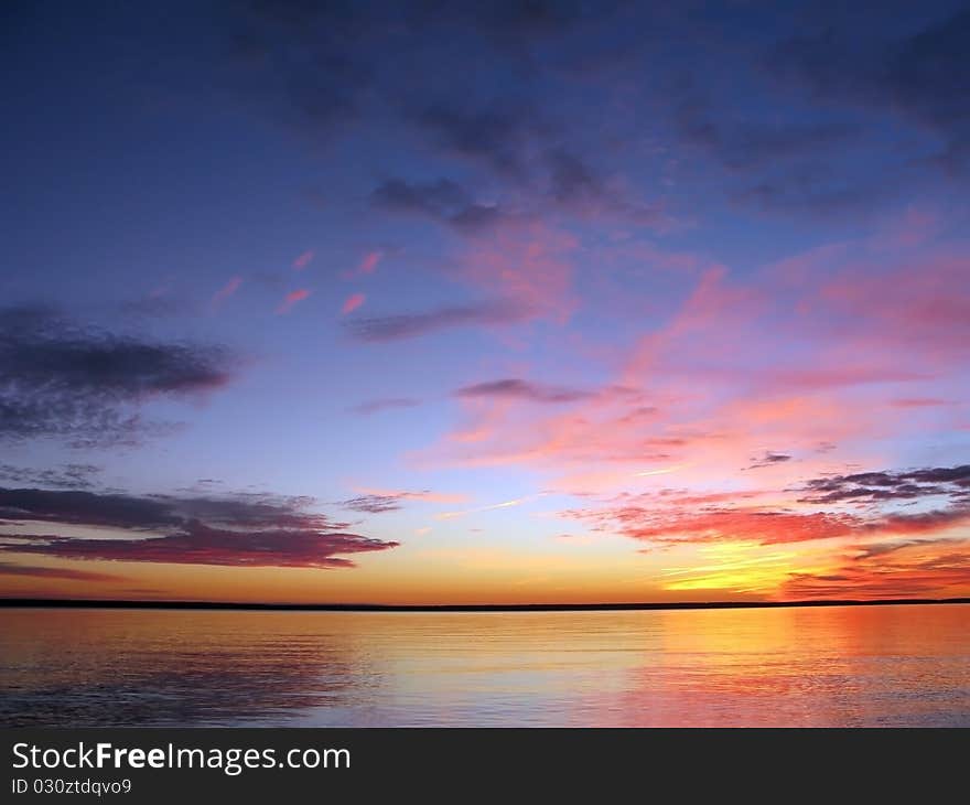 Sun is rising behind dark clouds. Sun is rising behind dark clouds