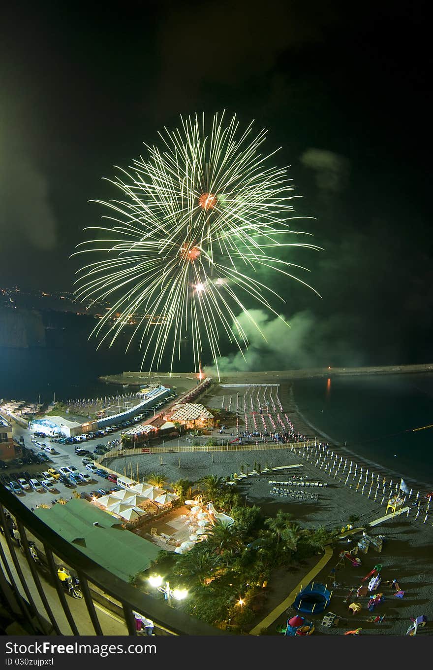 Green firework with Sorrento (Italy) landscape during annual firework contest. Green firework with Sorrento (Italy) landscape during annual firework contest