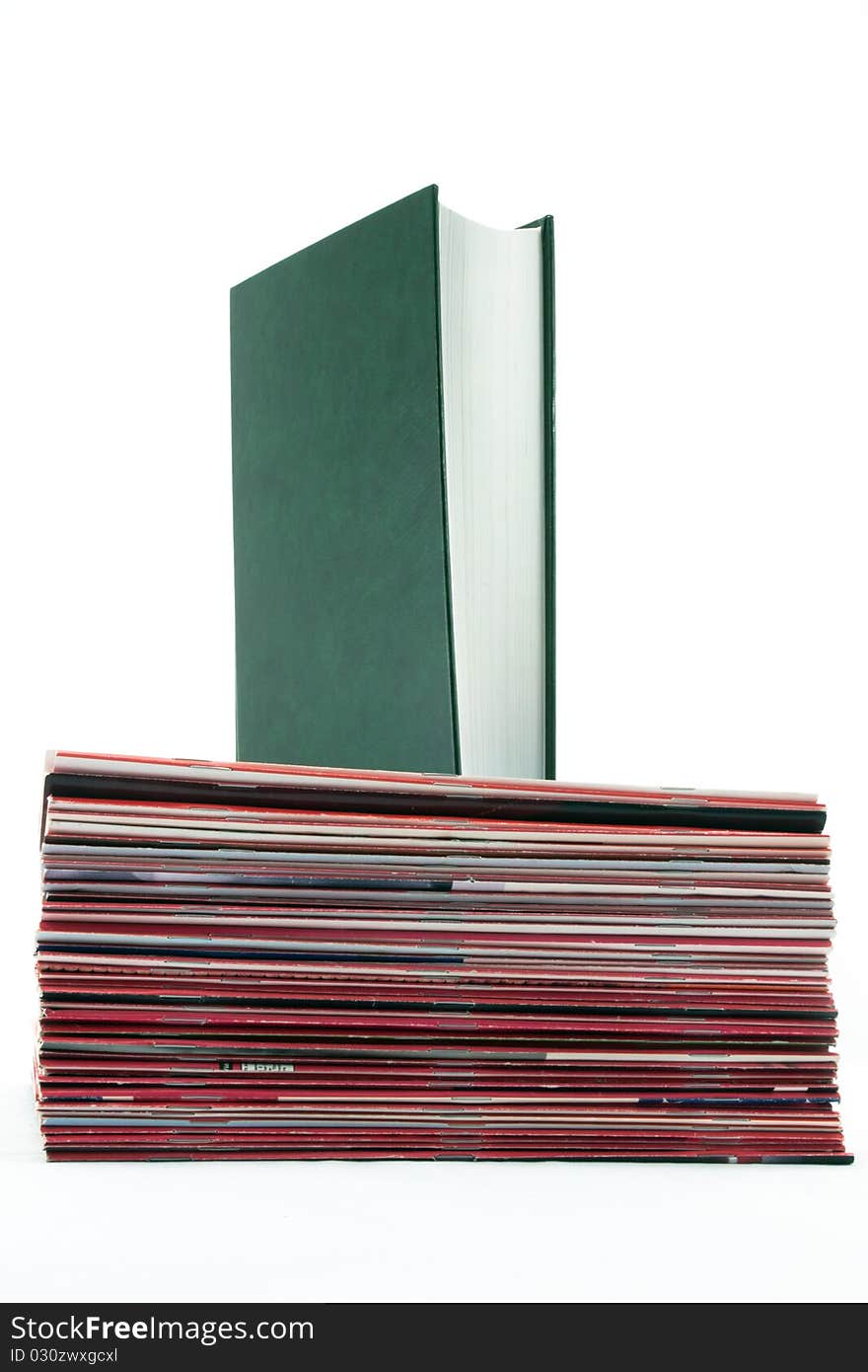 Standing book over a Pile of Magazines on a white background. Standing book over a Pile of Magazines on a white background