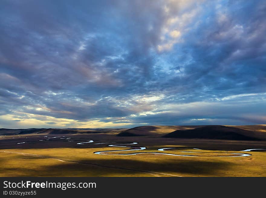 Stream between pastures and sky. Stream between pastures and sky