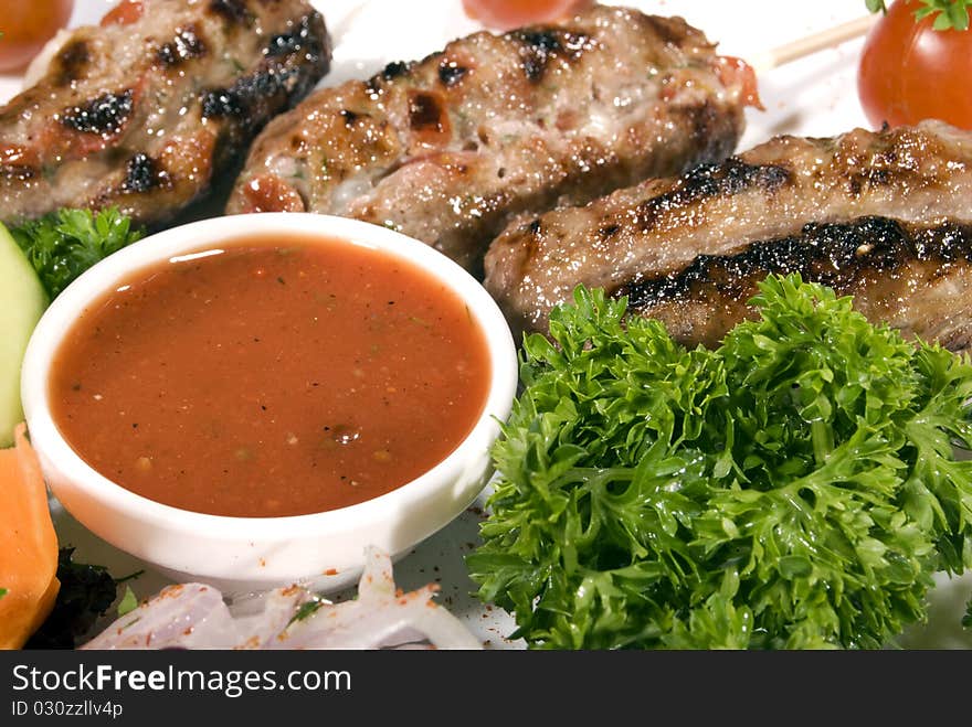 Fried meat served with tomato sauce and salad