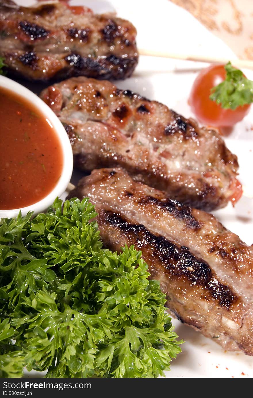 Fried meat served with tomato sauce and salad