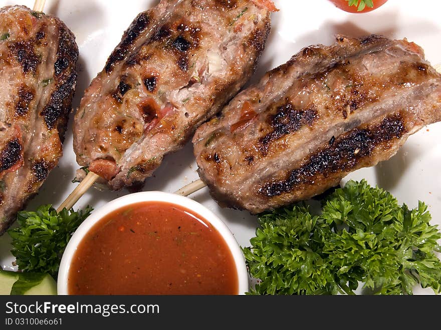 Fried meat served with tomato sauce and salad