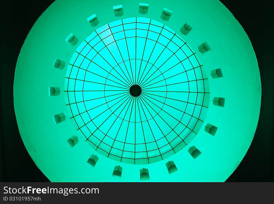 A dome inside a mosque turn into green color reflected by the transparent green material at top the dome. A dome inside a mosque turn into green color reflected by the transparent green material at top the dome.