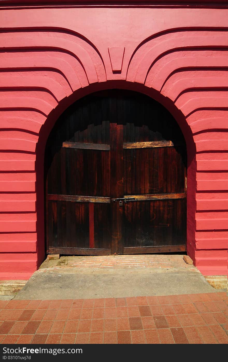 An old beautiful red arch with door at Melaka. An old beautiful red arch with door at Melaka.