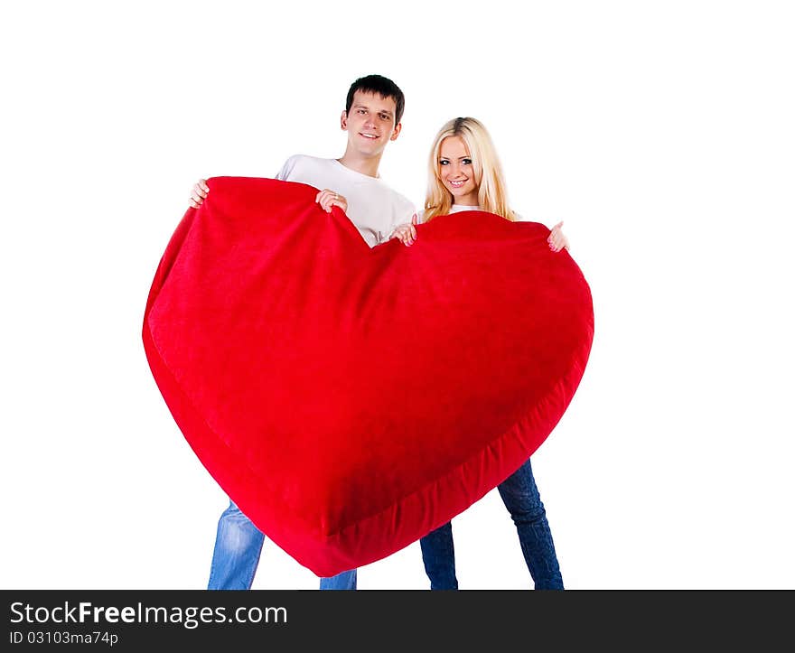 Young couple with a big heart on white background