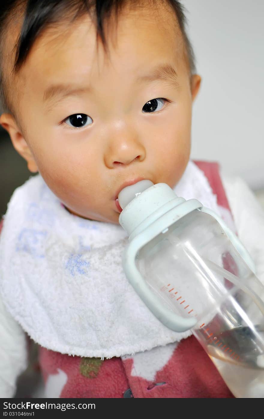 A old Asian baby boy drinking bottle milk. A old Asian baby boy drinking bottle milk