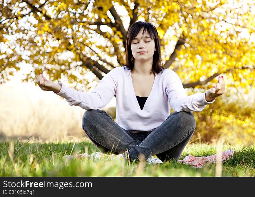 Beautiful brunette girl at the park. Outdoor shot.