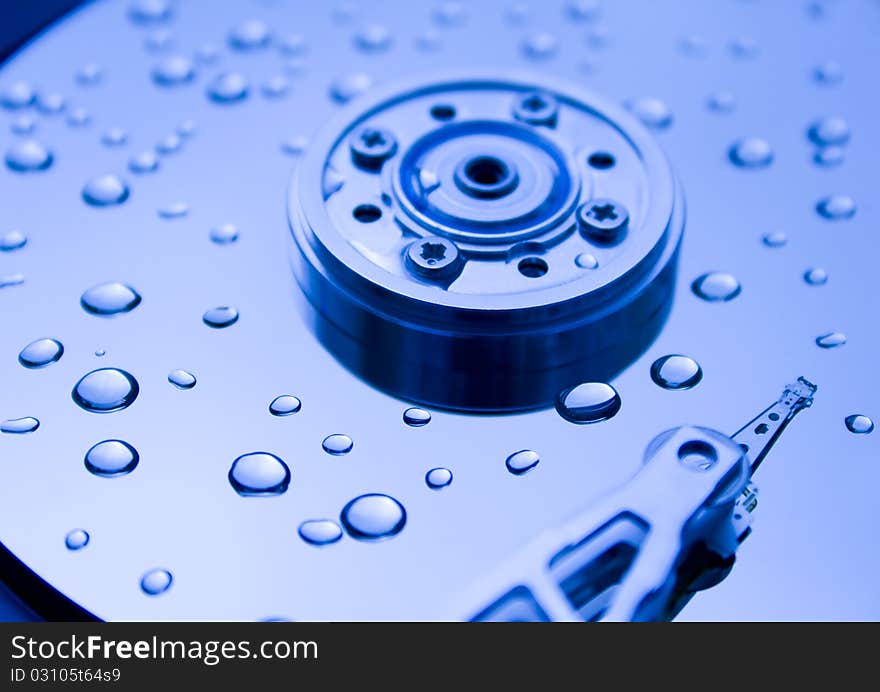 Closeup of read/write head of a computer hard drive and water drops. Closeup of read/write head of a computer hard drive and water drops