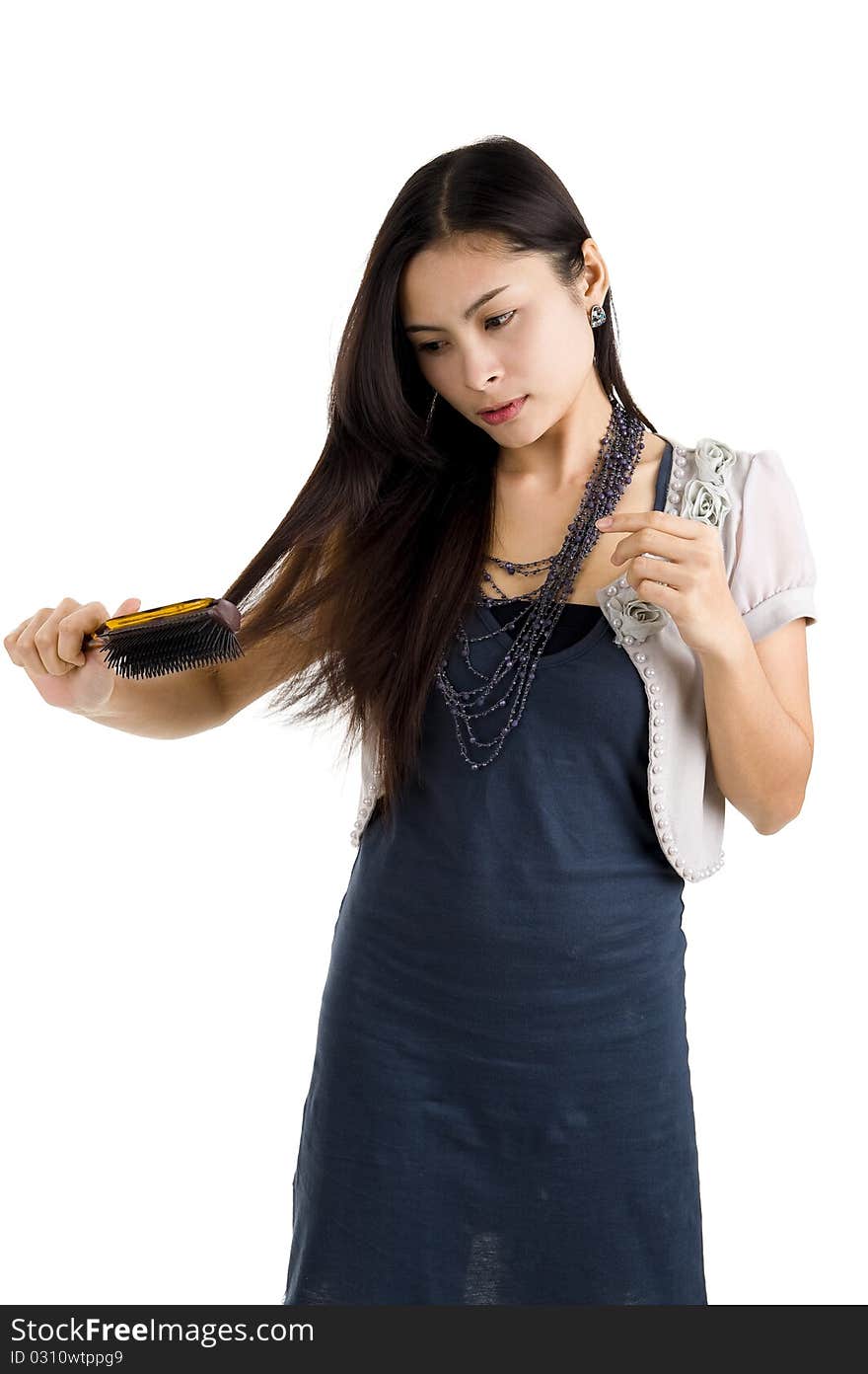 Pretty woman brushing her long hair, isolated on white background. Pretty woman brushing her long hair, isolated on white background