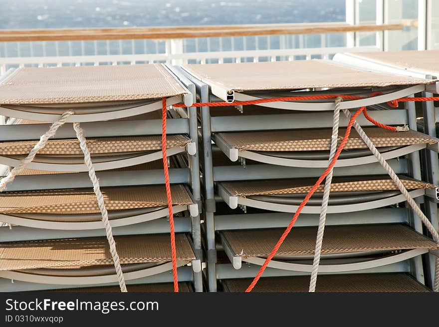 Cruise ship chairs stacked in rows during storm