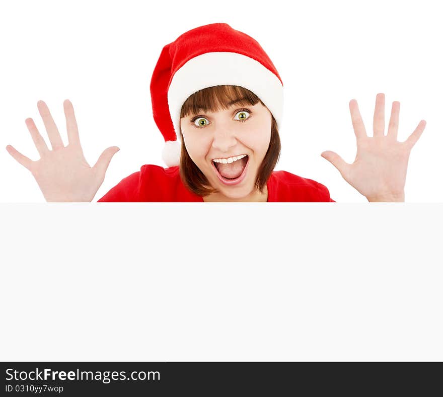 Surprised woman in Santa red hat peeking from blank billboard, isolated on white. Surprised woman in Santa red hat peeking from blank billboard, isolated on white