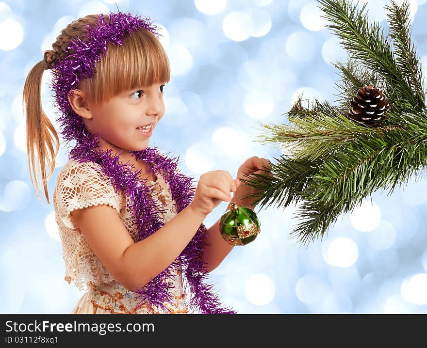 Little girl decorating artificial christmas firtree. Little girl decorating artificial christmas firtree