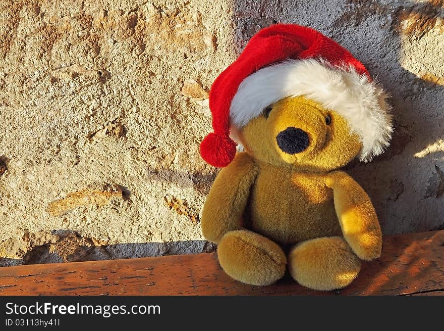 Teddy bear sitting position and wearing a cap Christmas. Teddy bear sitting position and wearing a cap Christmas