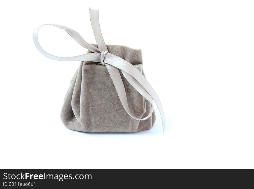 Small bag with ribbon isolated on white. Small bag with ribbon isolated on white.