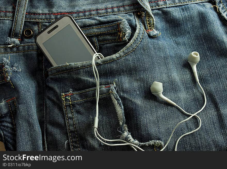 Mp3 player and  Mobile Phone  in a biue jeans pocket