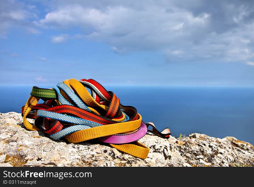 Colored ropes on the rock against the blue sky