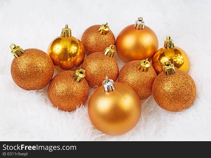 Christmas golden orange spheres on a white fur