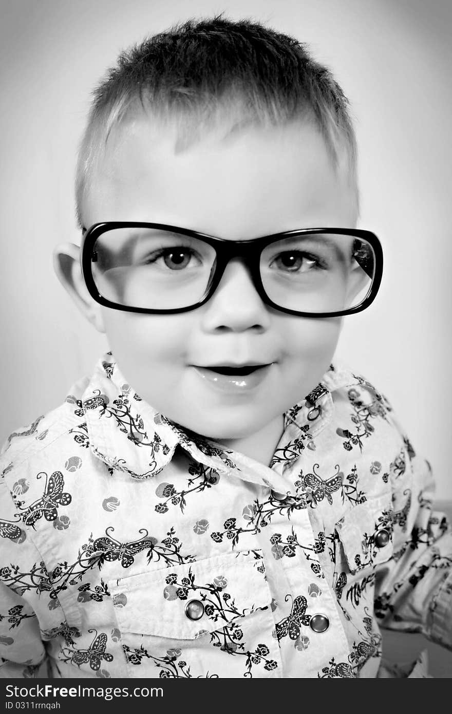 black - white picture of a boy with glasses